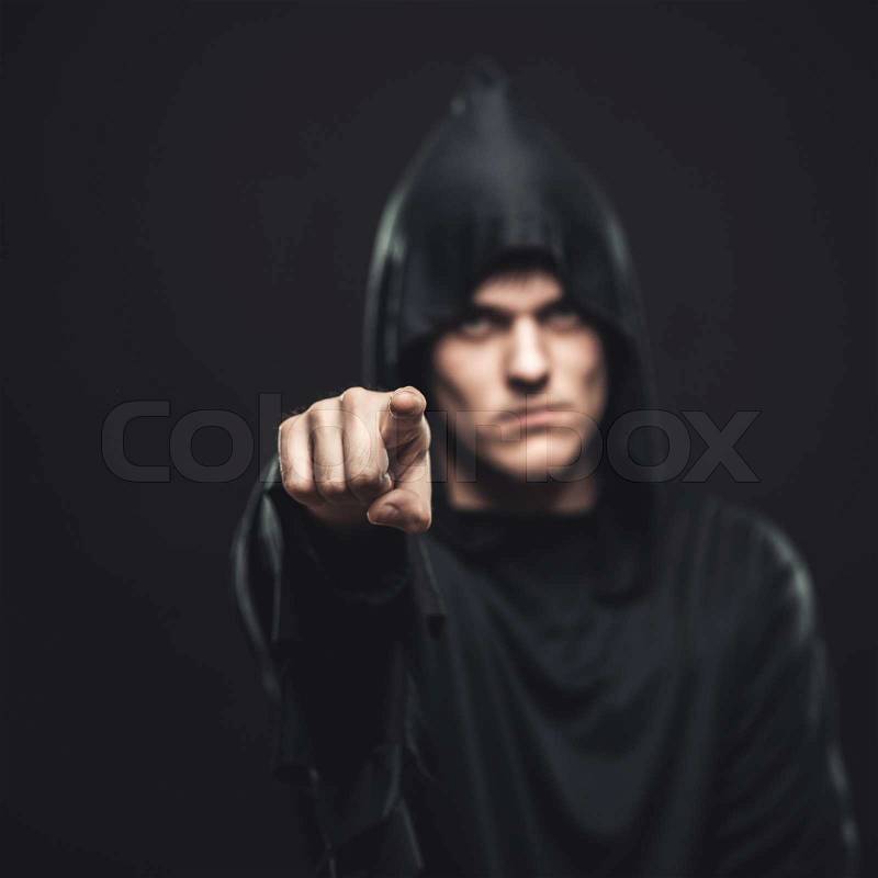 The guy in the black robe indicates you, stock photo