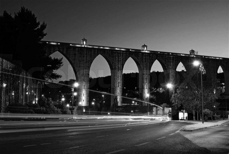 Night shoot of the historic aqueduct in the city of Lisbon built in 18th century, Portugal black and white, stock photo