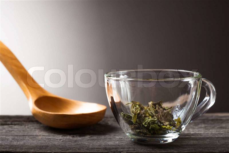 Cup of green mint tea and spoon with dry mint, stock photo