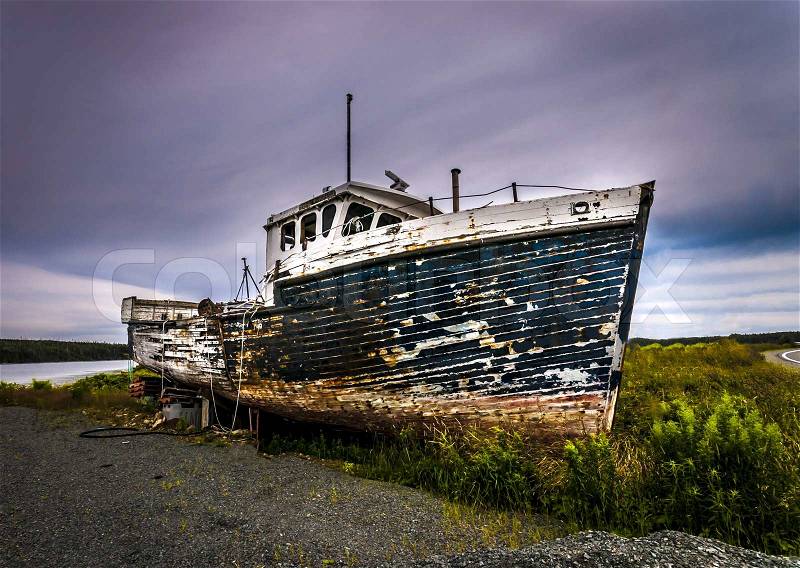 Abandonned rusty boat located on a panoramic route to Halifax Nova Scotia Canada, stock photo