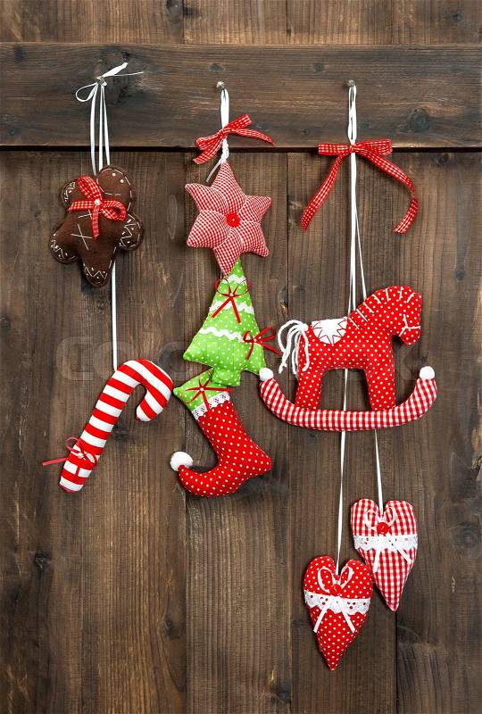 Christmas decoration handmade toys hanging over rustic wooden background. nostalgic retro style picture, stock photo