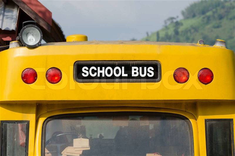 Yellow back of school bus with a sign , stock photo