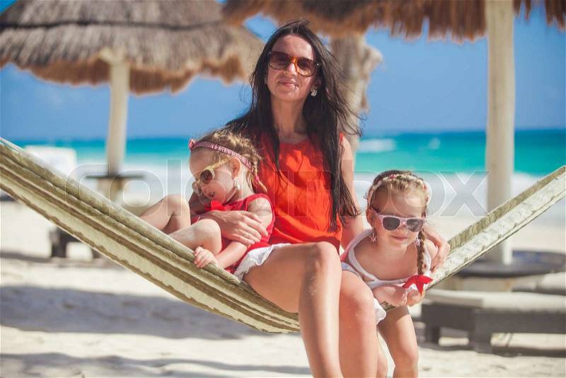 Mom with her children rest in a hammock, stock photo