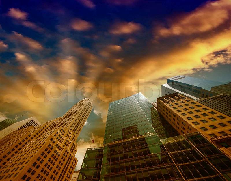 Looking up Lower Manhattan skyscrapers at sunset, New York City, stock photo