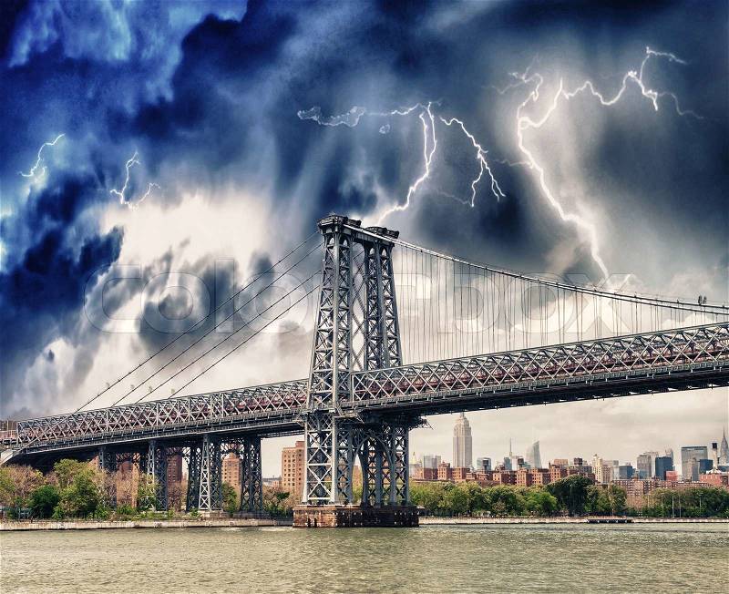 Storm above Manhattan Bridge structure and East River - New York, stock photo