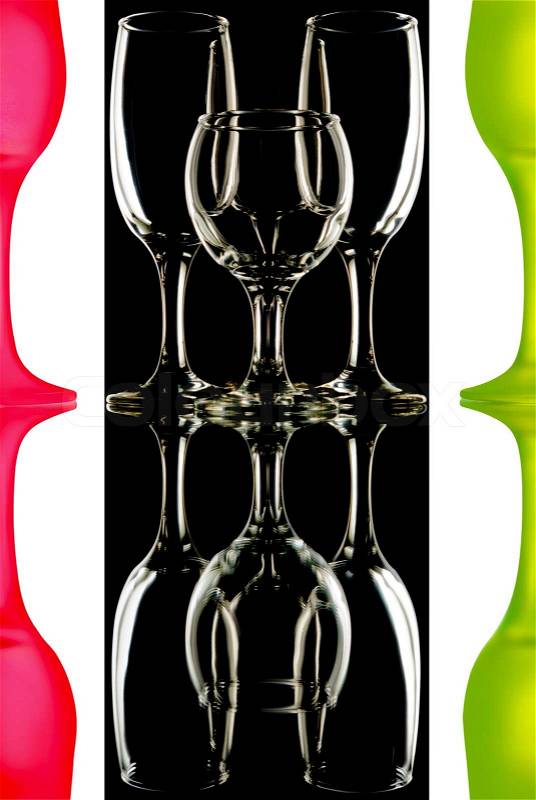 Transparent and the red-green wine glasses on the black-and-white background with reflection, stock photo