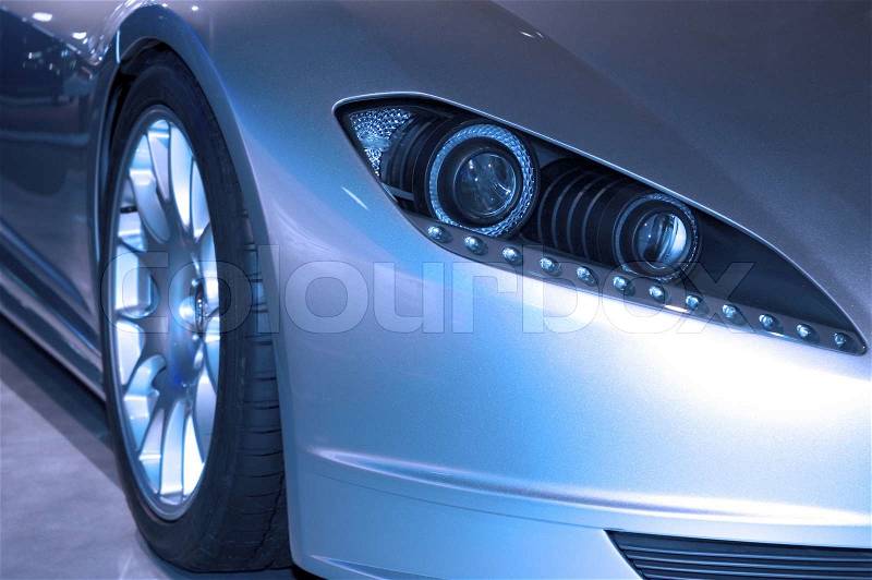 Modern looking front headlight assembly of a new 2006 sports luxury car. Many more car photos iin my gallery, stock photo