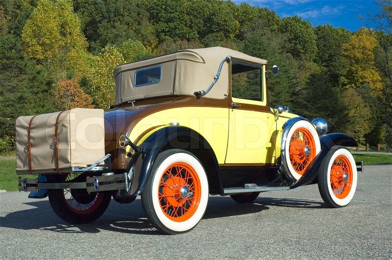 1931 Antique Model A with an unusual but authentic paint scheme. The colors of the car match the fall pallet of the trees in the background, stock photo