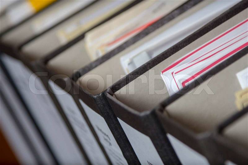 A Row of binders with sheets and files in an office archive, shallow depth of field, stock photo