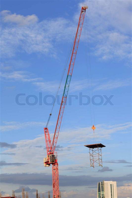 Construction site with crane worker and building, stock photo