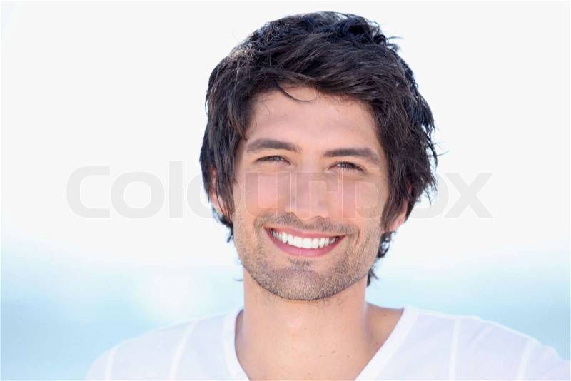 Portrait of beaming young man, stock photo