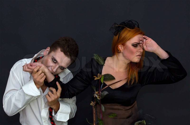 Witch and a vampire on a dark background, stock photo