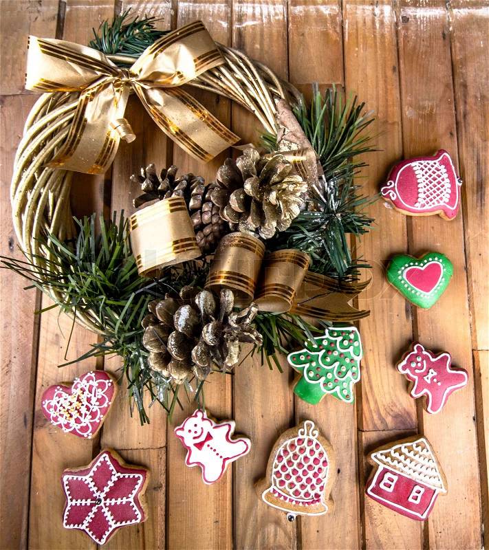 Christmas wreath and gingerbread on the wood, stock photo