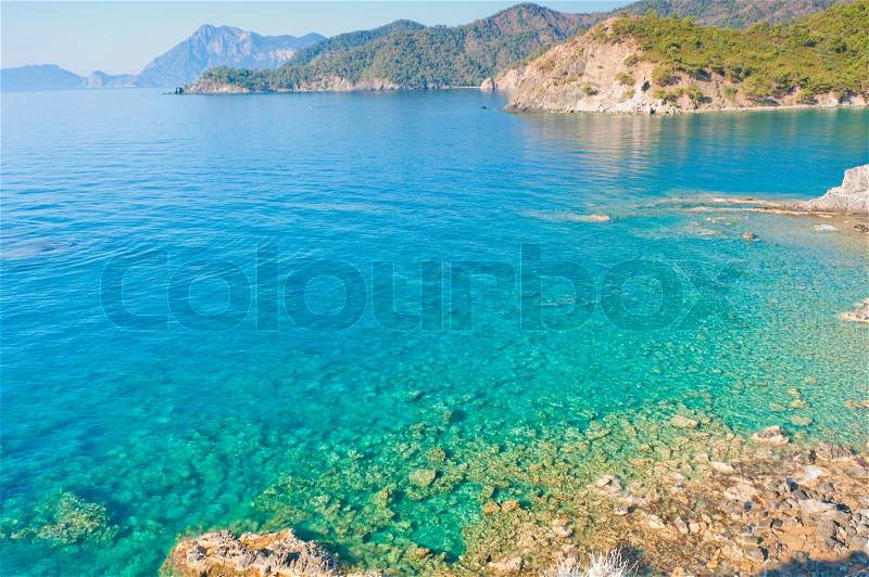 Clear turquoise water and rocky shore, stock photo