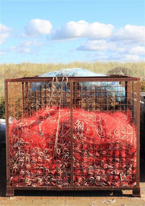 Red industry fishing net in rusty metal grid, stock photo