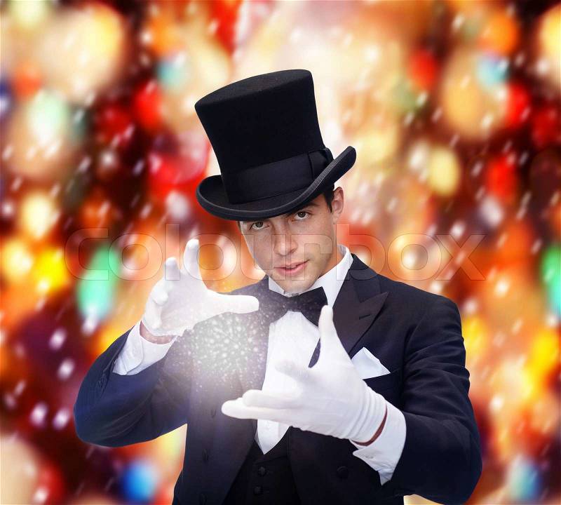 Magic, performance, circus, show concept - magician in top hat showing trick, stock photo