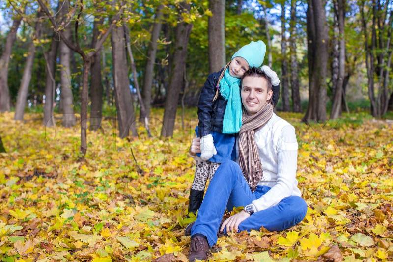 Cute little girl with happy daddy enjoy their autumn vacation on a sunny day, stock photo