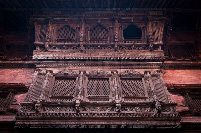 Hindu temple architecture detail. Carved wooden window on old Royal Palace. Nepal, Kathmandu, Durbar Square, Hanuman Dhoka, stock photo