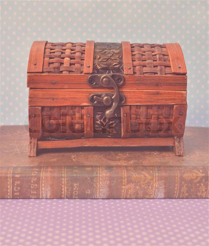 Decorative vintage chest box on old book, stock photo