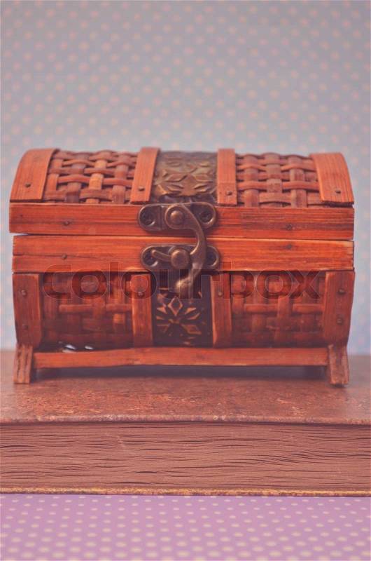 Decorative chest box on old book, stock photo