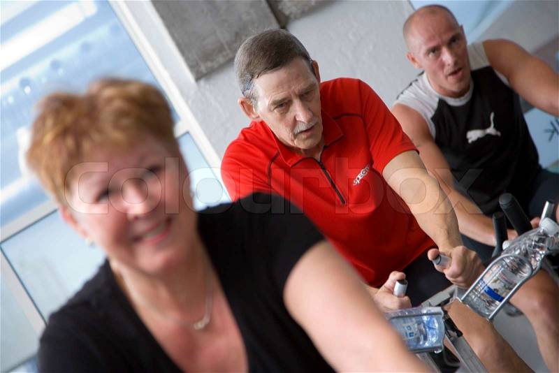 Elderly people in a fitness center, stock photo