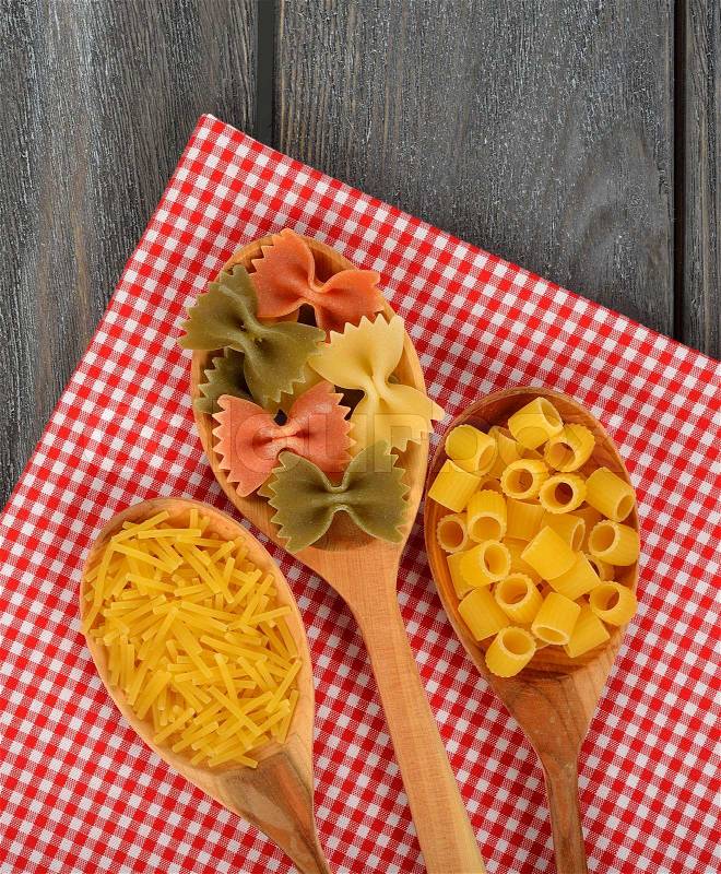 Uncooked pasta in a spoon, stock photo