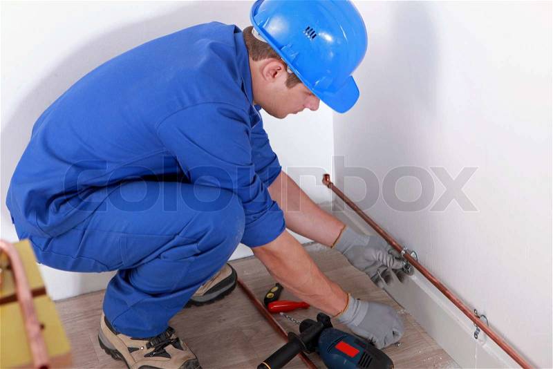 Plumber fitting pipes, stock photo