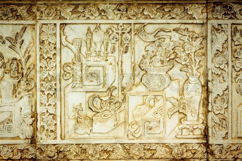 Traditional Chinese stone engrave art wall at Thai public temple, stock photo