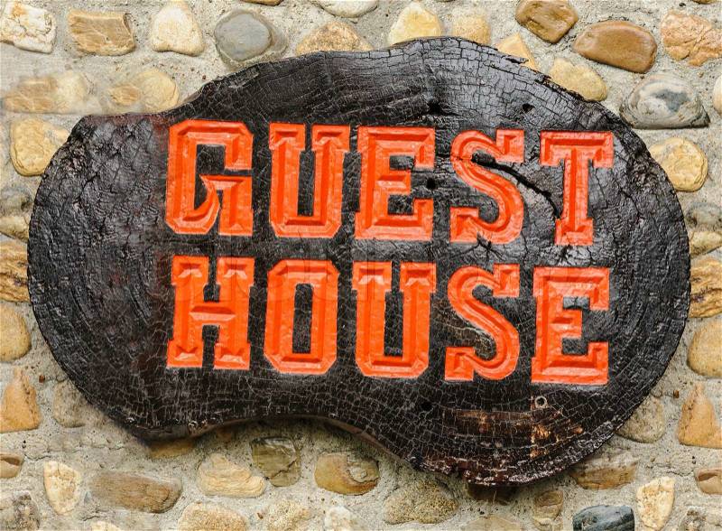 Old retro wood sign with the text Guest house in Thailand, stock photo
