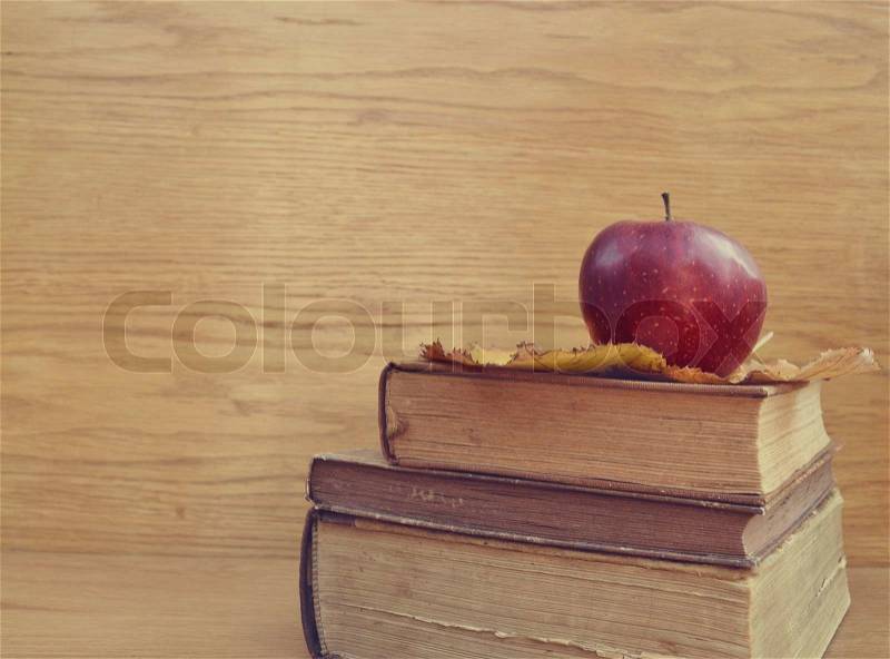 Vintage old books and apple, stock photo