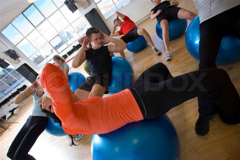 Caucasian women and men in fitness center, stock photo