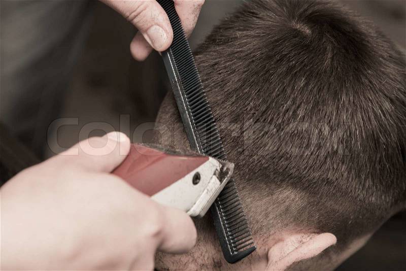 Barber cutting hair with clipper - a series of BARBER images, stock photo