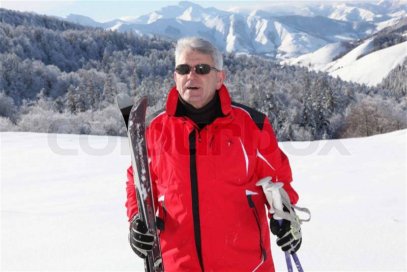 Middle aged staying fit by skiing, stock photo