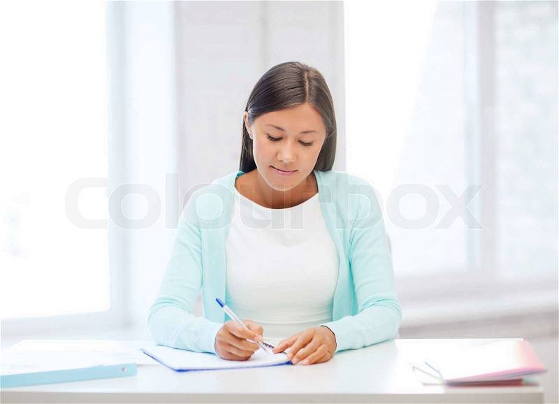 Education, school and business concept - international student studying in college, stock photo