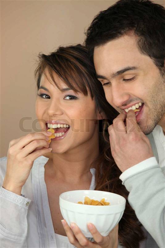 Couple eating cereal, stock photo
