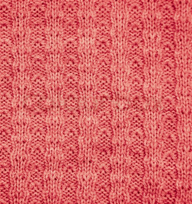Red knitted fabric as a background macro, stock photo