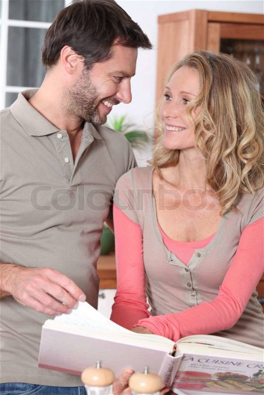 Couple with a cookbook, stock photo