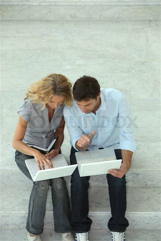 Couple with two computers, stock photo