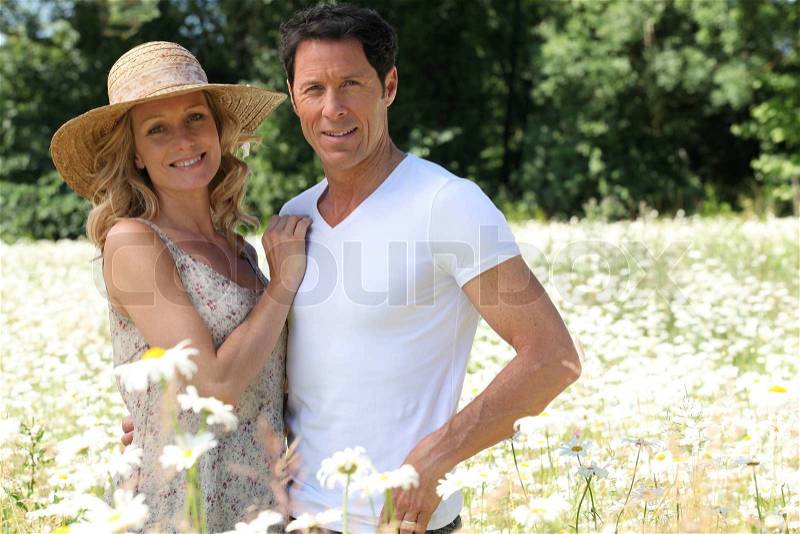 Couple in field of flowers, stock photo