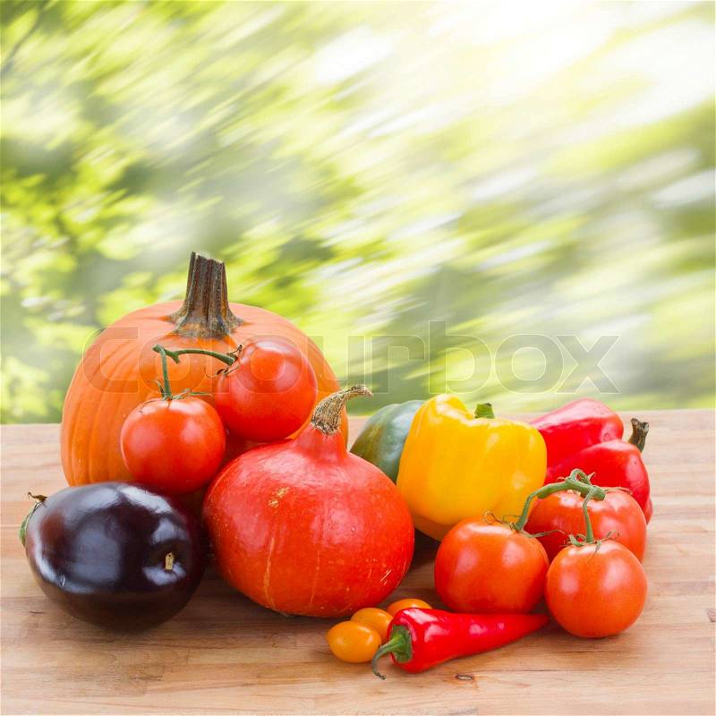 Fall ripe of colorful vegetables on table in garden, stock photo