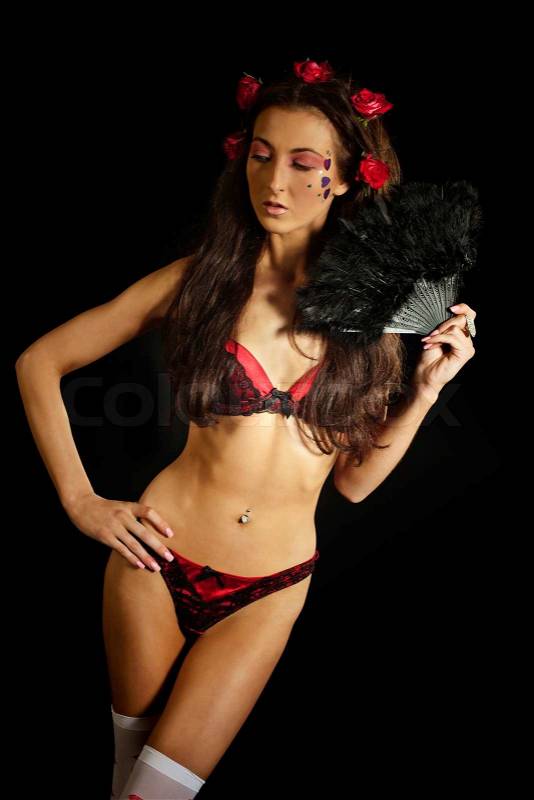 Young woman with black fan wearing lingerie, stock photo
