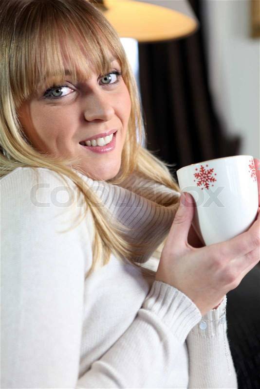 Woman holding mug, stock photo