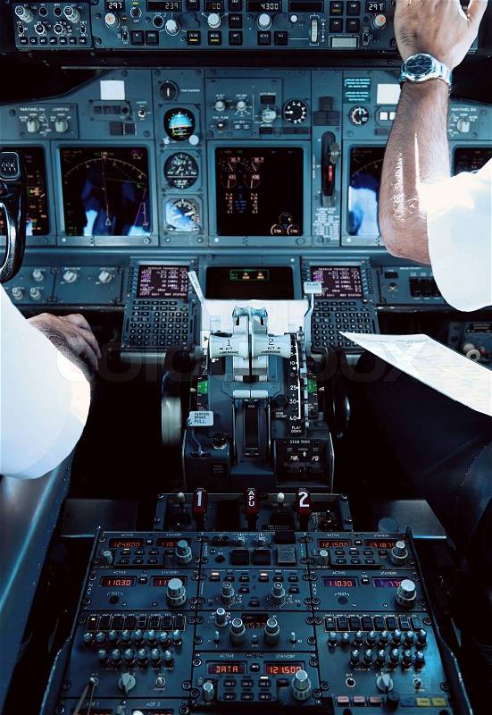 Airliner Cockpit with Pilots Working, stock photo