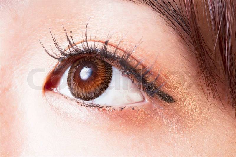 Closeup of Female eye with brown contact lenses macro, stock photo