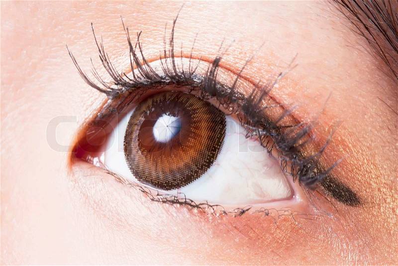 Closeup of Female eye with brown contact lenses macro, stock photo