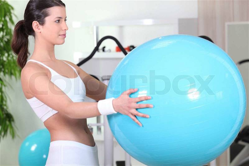 Brunette holding inflatable gym ball, stock photo
