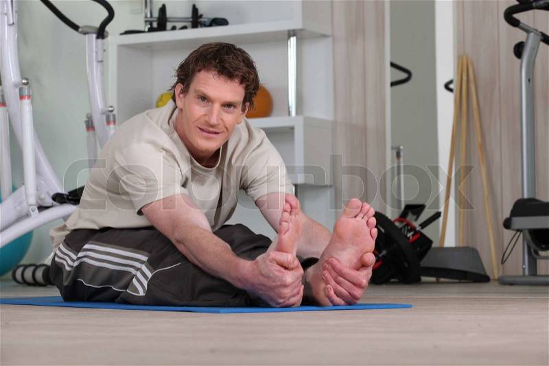 A man doing fitness at home, stock photo