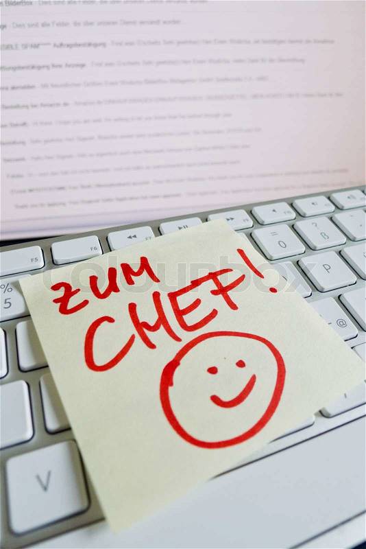 A sticky note is on the keyboard of a computer as a reminder: for chief, stock photo