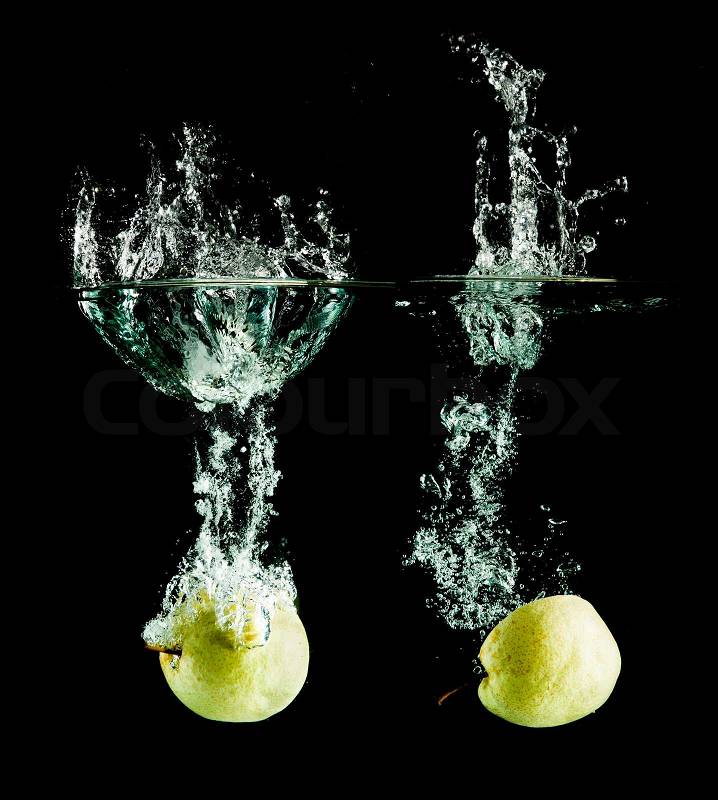 Oriental pear in water on a black background, stock photo