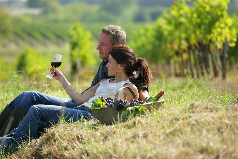 Couple tasting wine at a vineyard, stock photo
